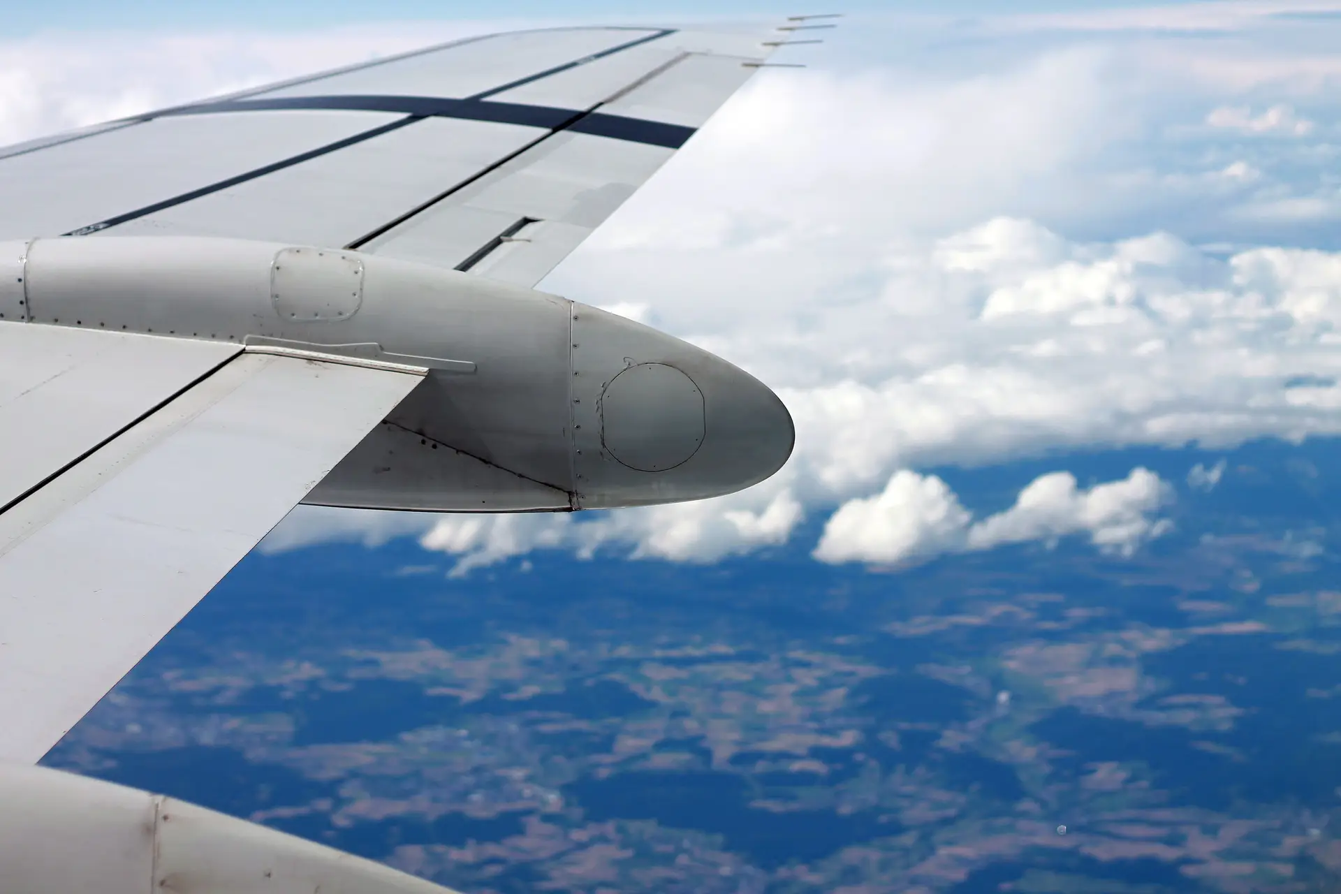 Airplane wing traveling serenely above Canadian terrain