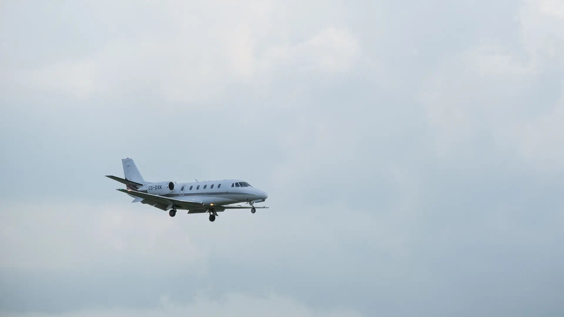 Private aircraft gliding gracefully above atmospheric clouds across Canadian airspace