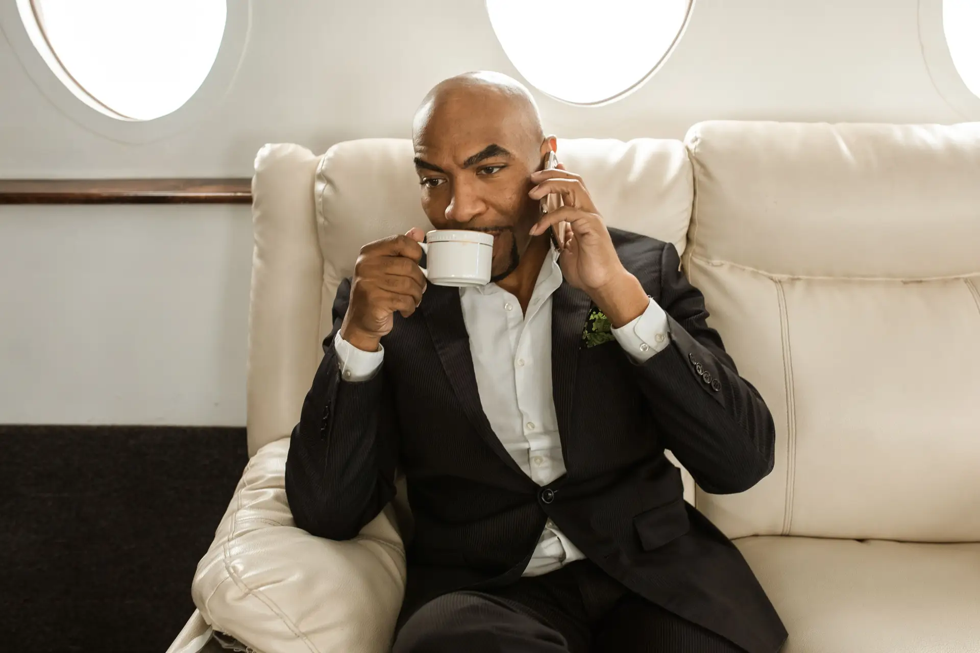 Executive passenger reviewing tailored flight schedule inside private jet interior