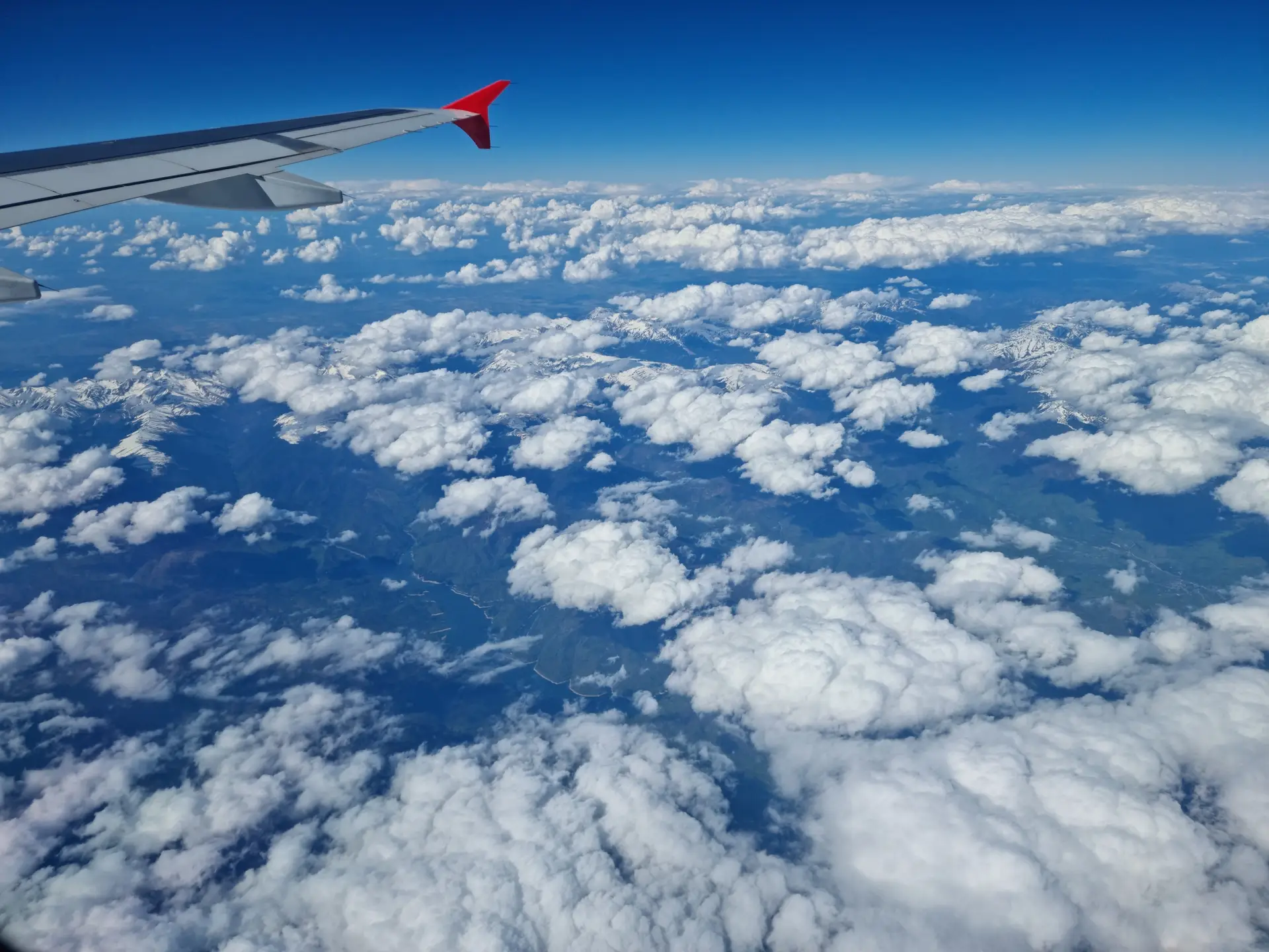 Serene vast clouds and mountains view from flight